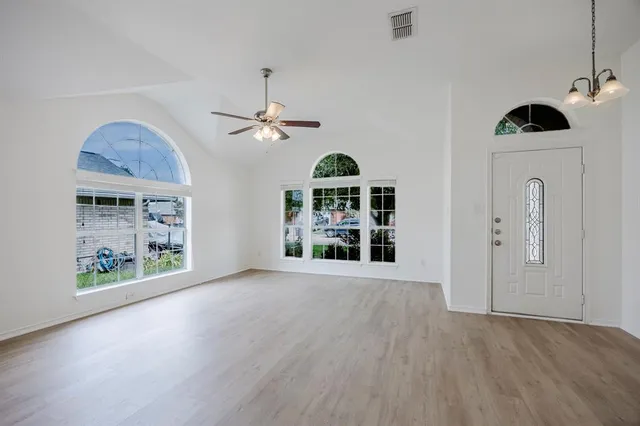 a view of an empty room with a window and workspace