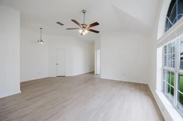 wooden floor in an empty room with a window