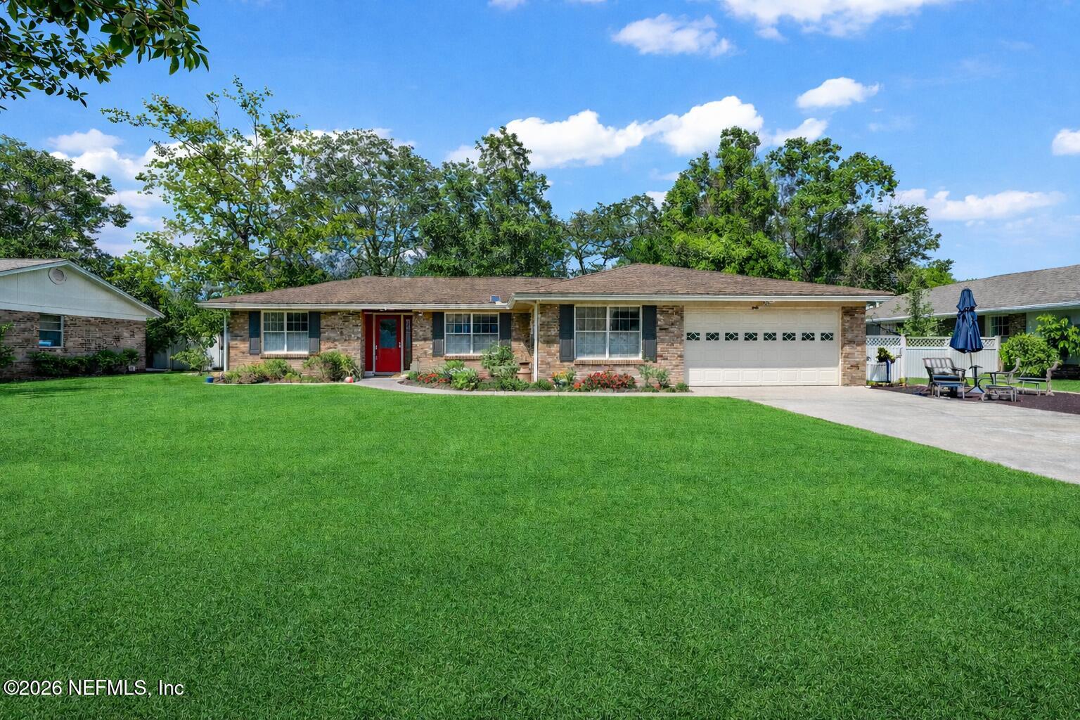 a view of a house with a yard and sitting area