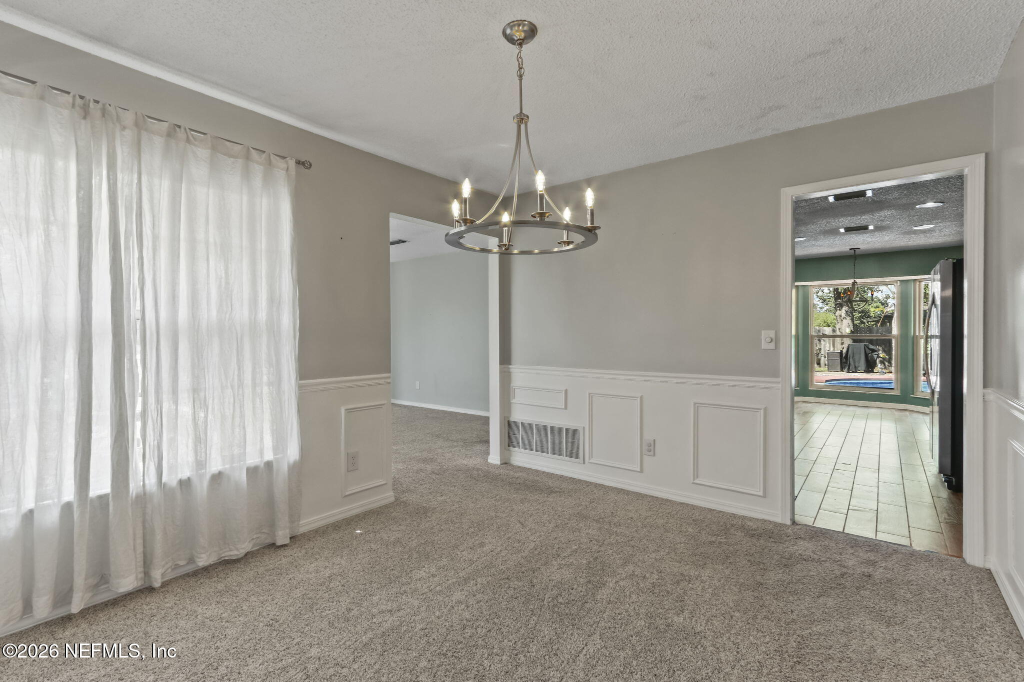 120 Vanderford Road North Orange Park, FL 32073 - Photo 12 of 40 a view of a livingroom with a chandelier fan and windows