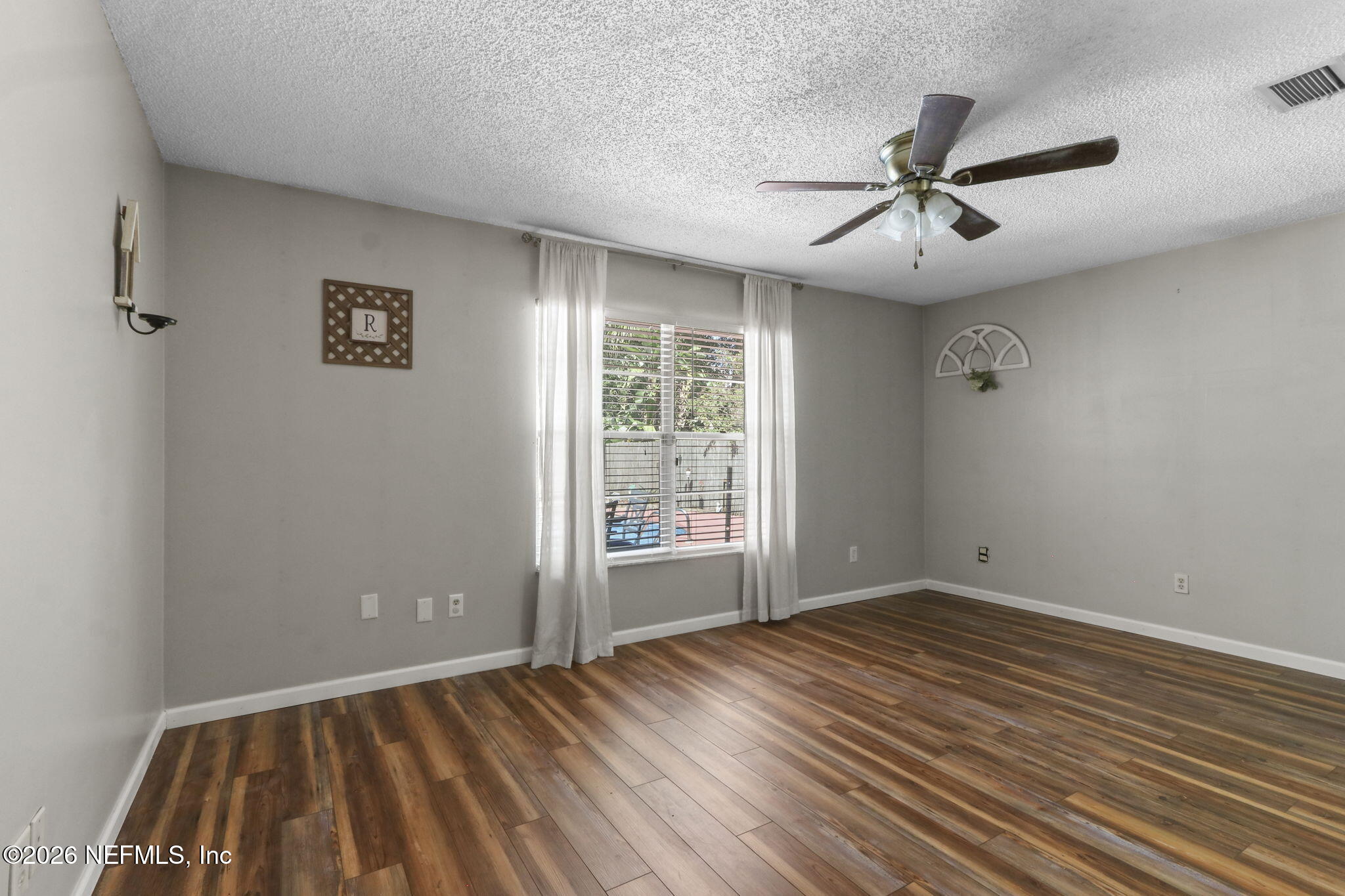 120 Vanderford Road North Orange Park, FL 32073 - Photo 22 of 40 a view of an empty room with wooden floor and a window