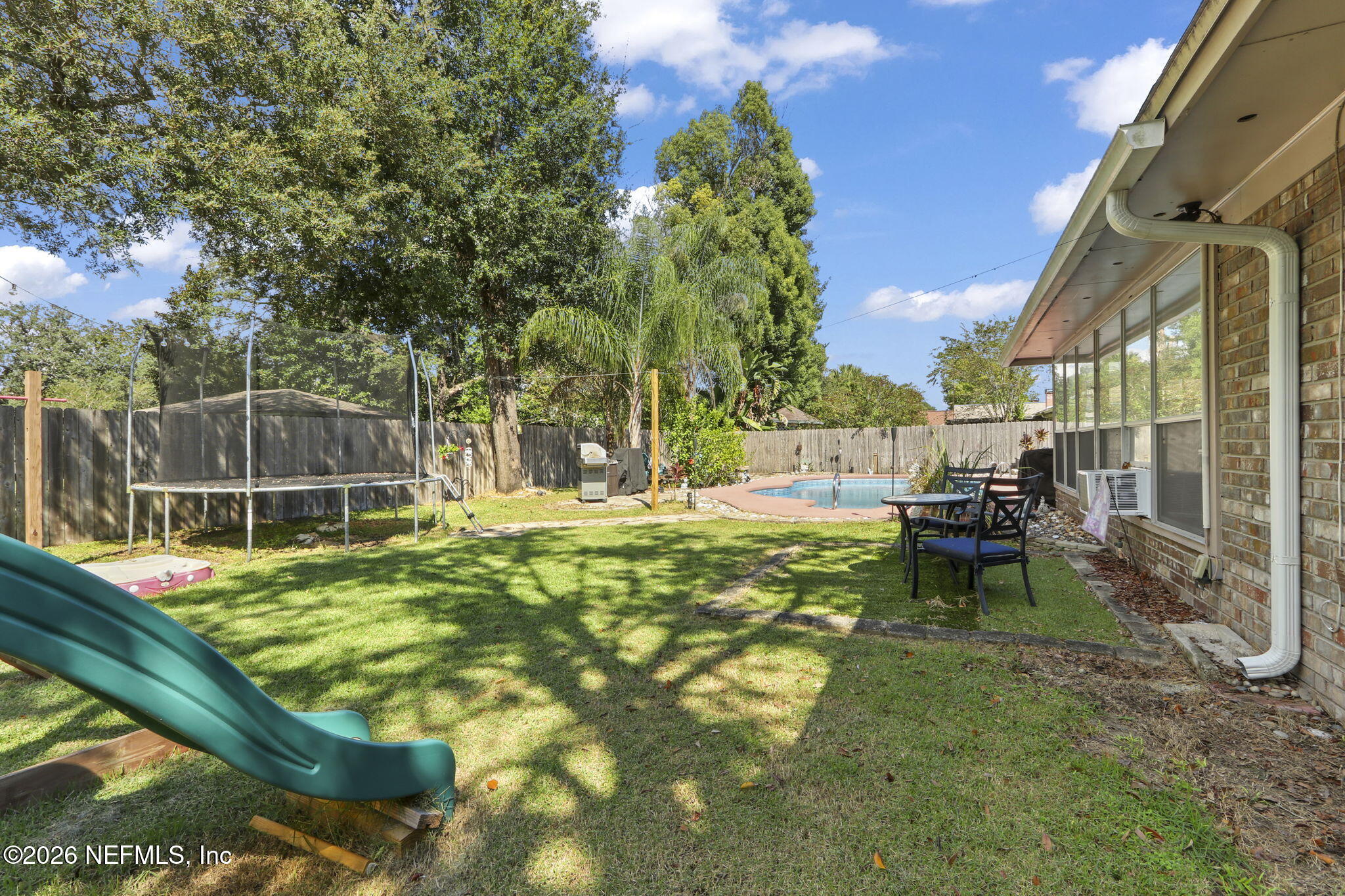120 Vanderford Road North Orange Park, FL 32073 - Photo 32 of 40 a backyard of a house with table and chairs