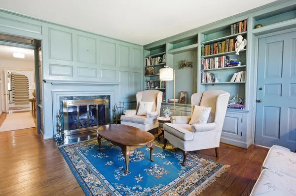 a living room with furniture ceiling fan and a window