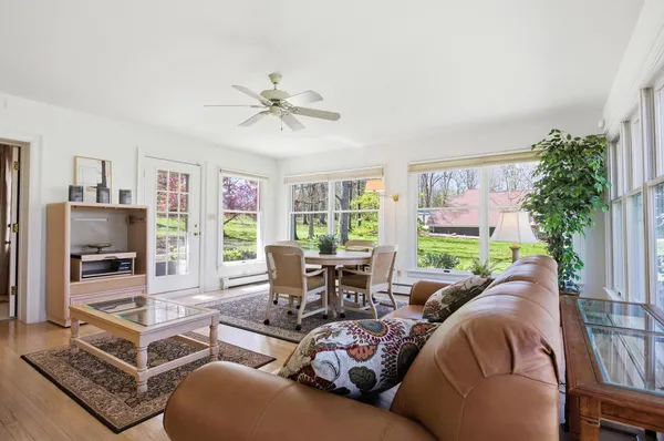 a living room with furniture a table and a large window