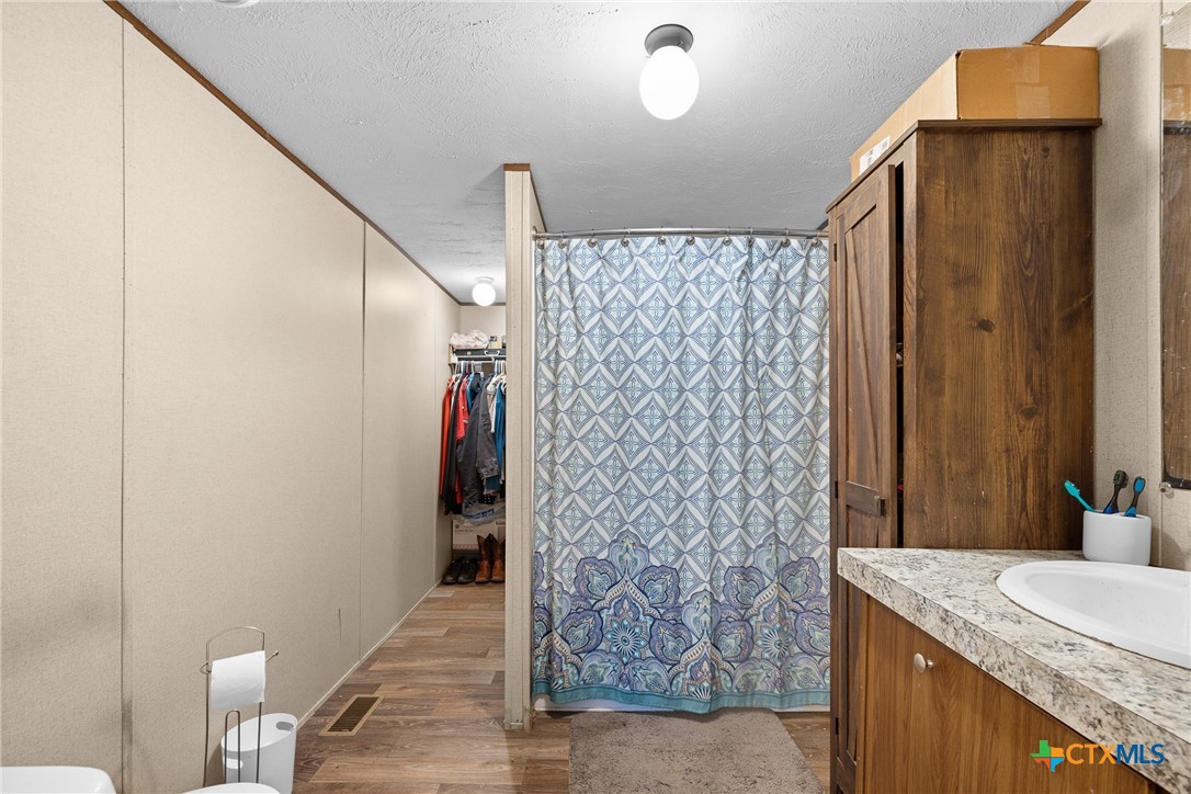 6497 Taylorsville Road Dale, TX 78616 - Photo 11 of 36 a bathroom with a granite countertop shower and a sink