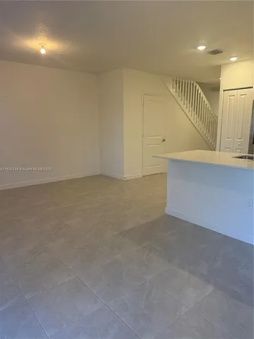 a bathroom with a shower sink vanity and toilet