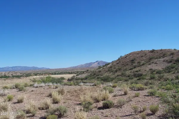 a view of a large mountain with mountains in the background