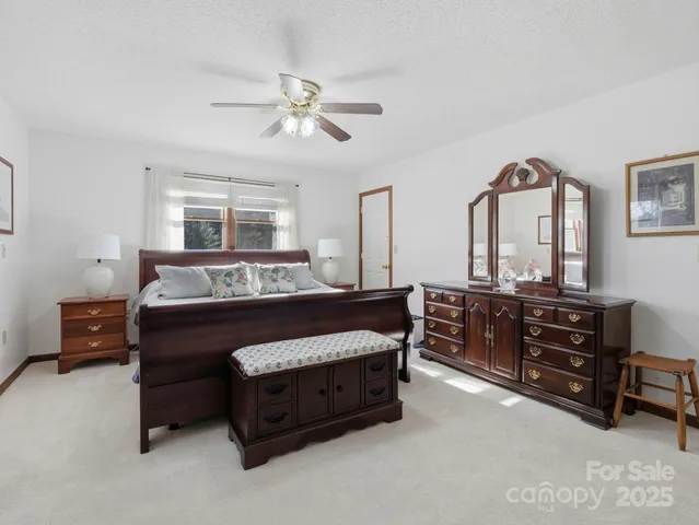 a bedroom with a bed and ceiling fan