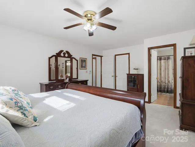 a bedroom with a large bed and a chandelier