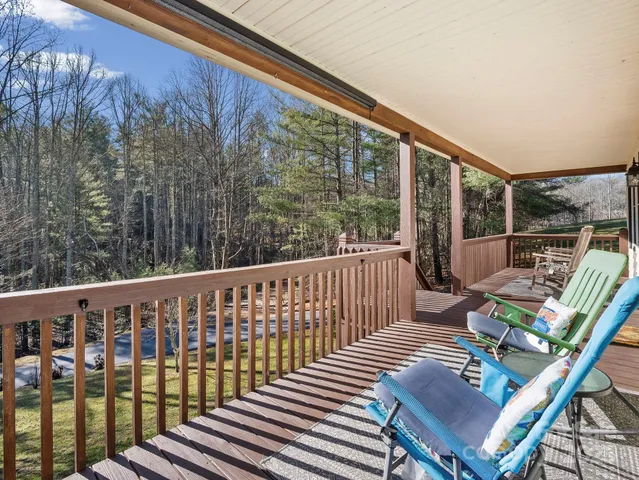 a view of balcony with wooden floor and outdoor seating