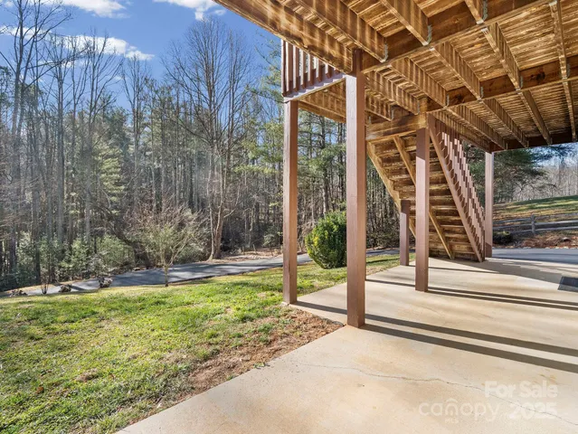 a view of a backyard with floor to ceiling windows