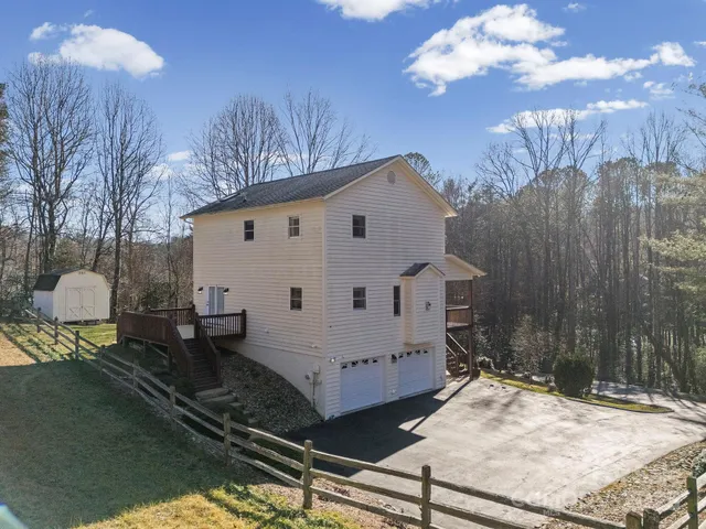 a view of a white house with a yard
