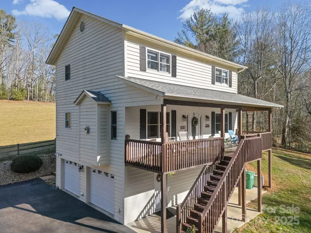 a view of a house with backyard and deck