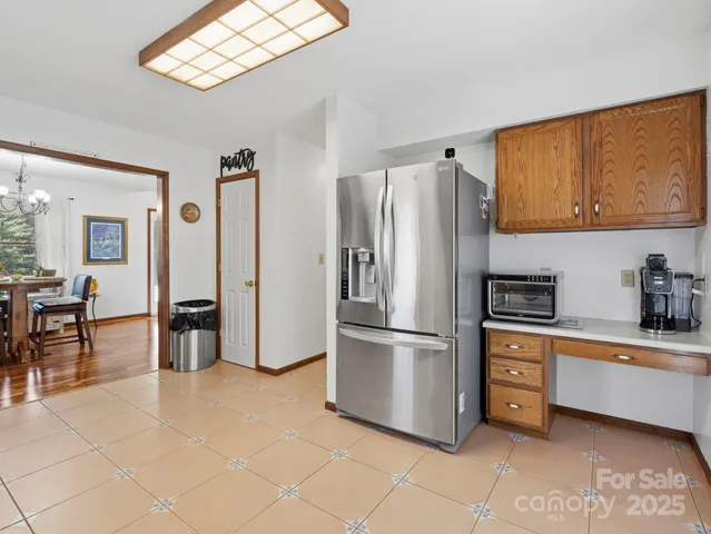 a kitchen with stainless steel appliances a refrigerator and a stove top oven