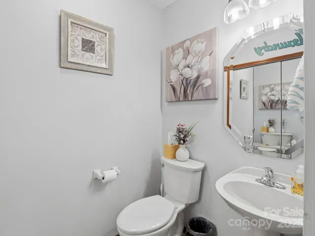a bathroom with a toilet a sink and a mirror