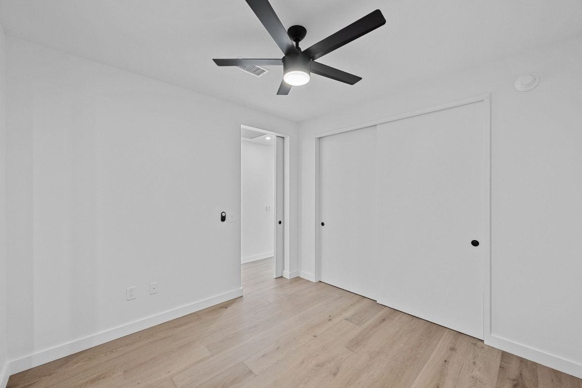 610 Davis Street, Unit 4308 Austin, TX 78701 - Photo 12 of 21 a view of a big room with wooden floor and a ceiling fan