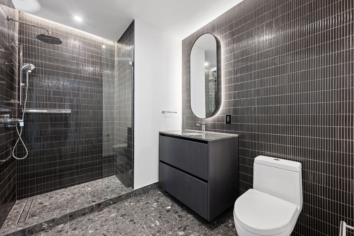 610 Davis Street, Unit 4308 Austin, TX 78701 - Photo 13 of 21 a bathroom with a toilet and a shower