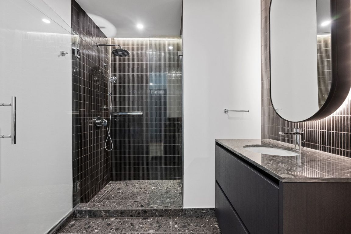 610 Davis Street, Unit 4308 Austin, TX 78701 - Photo 14 of 21 a bathroom with a sink a toilet and shower