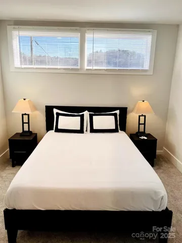 a large kitchen with kitchen island a dining table chairs and a wooden floor