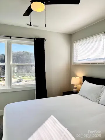 a large bed sitting in a bedroom and a lamp