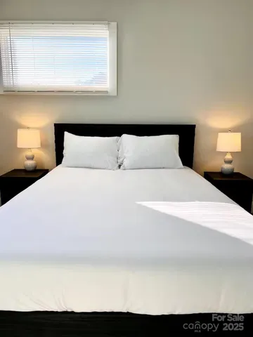 a bedroom with a bed and a window