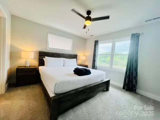 a bedroom with a bed chair and window