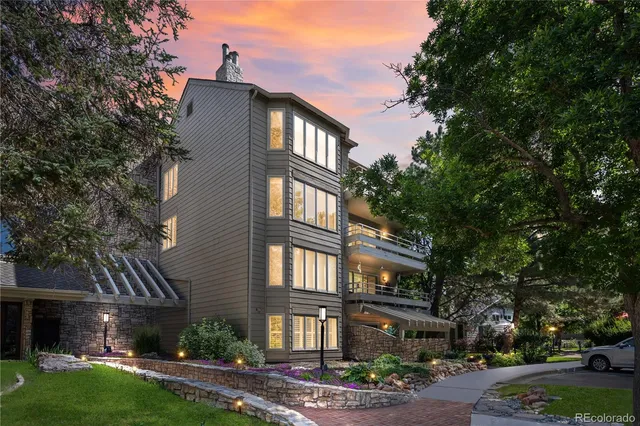 a front view of a residential apartment building with a yard