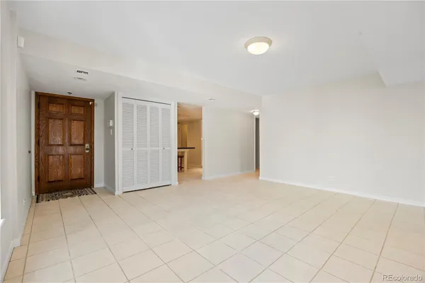 a large white bed sitting in a room next to a window