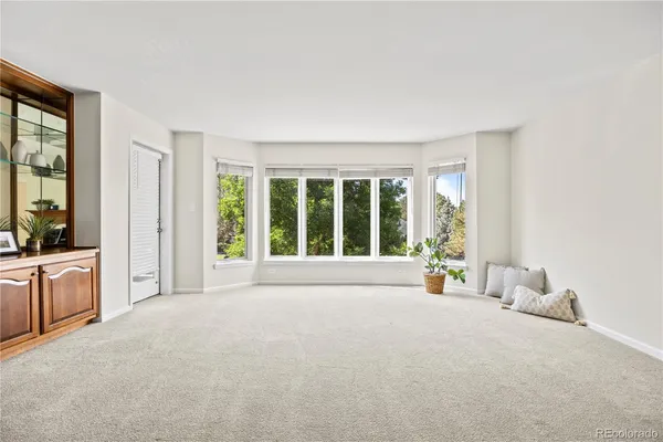 a view of an empty room with a fireplace and a window