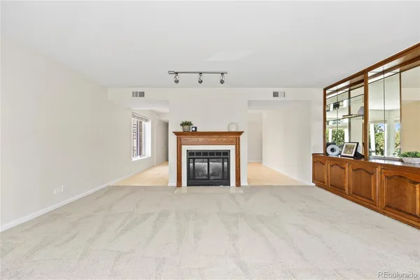 a view of an empty room with a fireplace