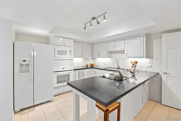 a kitchen with stainless steel appliances granite countertop a sink and cabinets