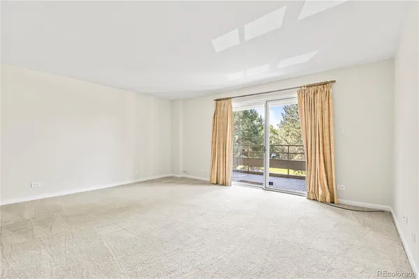 an empty room with a empty space and a window