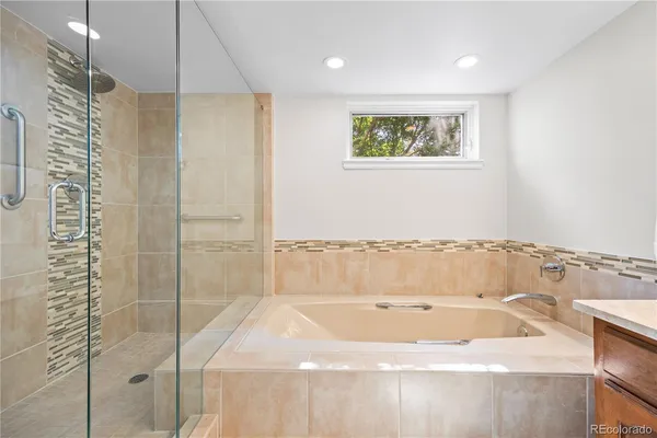 a bathroom with a bathtub and a shower