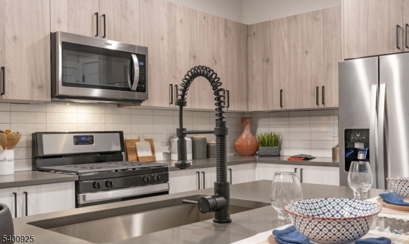 100 Union Street, Unit 353 Elizabeth, NJ 07202 - Photo 8 of 20 a kitchen with stainless steel appliances granite countertop a stove a microwave and a refrigerator