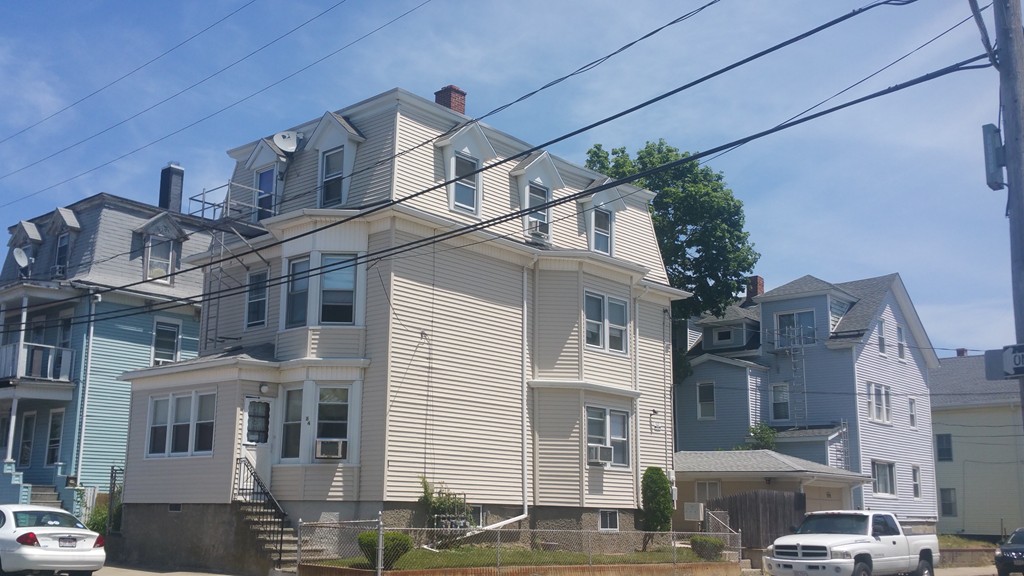 84 Coral Street Fall River, MA 02721 - Photo 1 of 2 a front view of a building with balcony