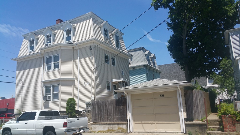 84 Coral Street Fall River, MA 02721 - Photo 2 of 2 a front view of a house with parking