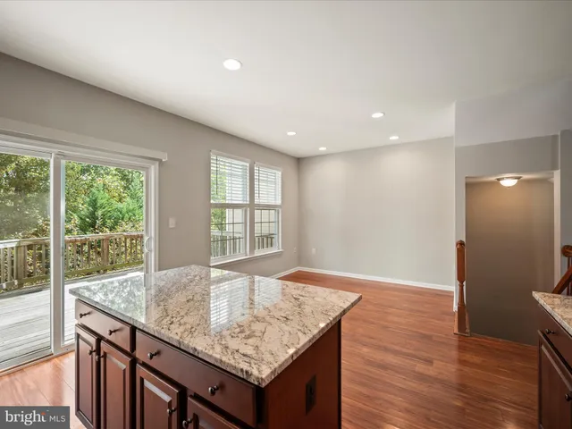 a view of kitchen island with wooden floor and window