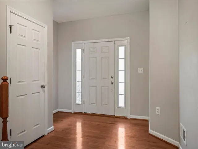 an empty room with wooden floor and closet