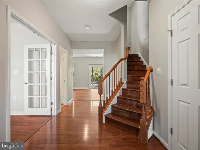 a view of entryway and hall with wooden floor