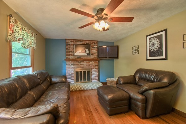 42 Emery Road Townsend, MA 01469 - Photo 16 of 30 a living room with furniture a fireplace and a large window