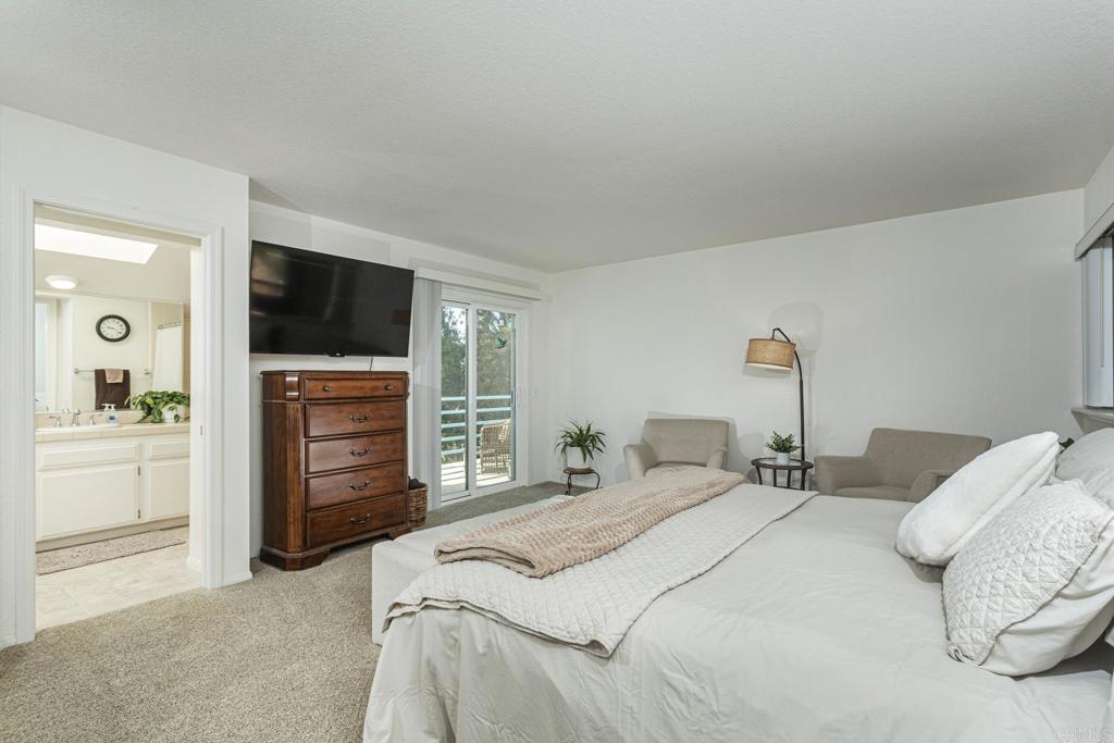656 Westlake Street Encinitas, CA 92024 - Photo 25 of 41 a bedroom with a bed and a flat screen tv