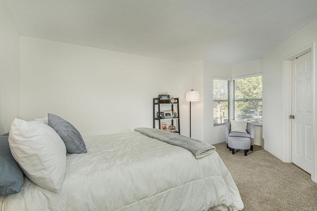 656 Westlake Street Encinitas, CA 92024 - Photo 29 of 41 a bedroom with a bed and a large window