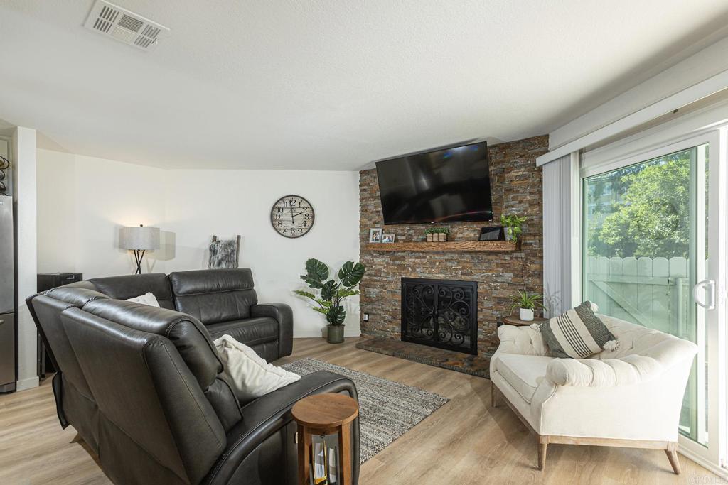 656 Westlake Street Encinitas, CA 92024 - Photo 4 of 41 a living room with furniture a fireplace and a flat screen tv