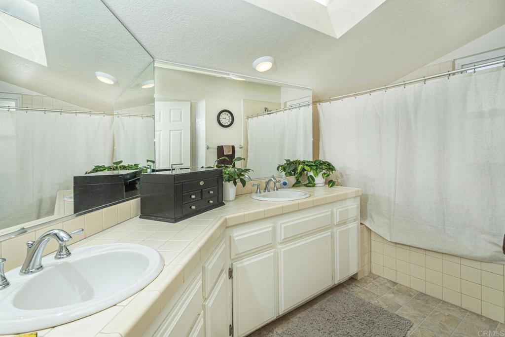656 Westlake Street Encinitas, CA 92024 - Photo 6 of 41 a bathroom with a double vanity sink and mirror