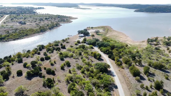 an aerial view of a house with outdoor space and lake view
