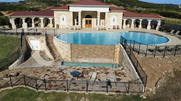 an aerial view of a house with swimming pool and patio