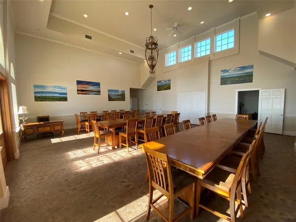a view of a dining room with furniture and a chandelier