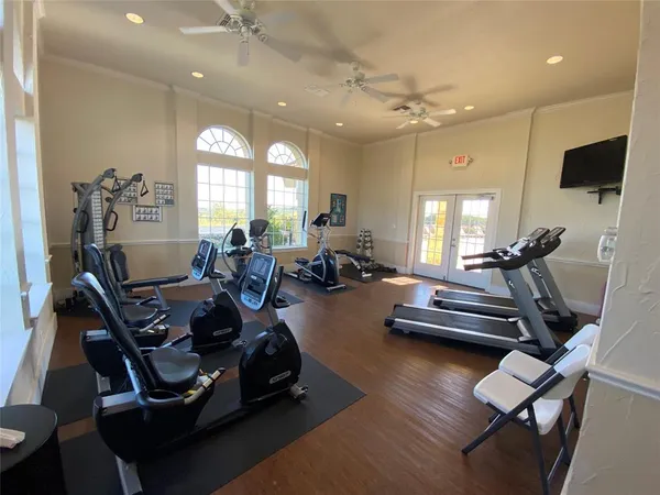 a room with gym equipment and a large window