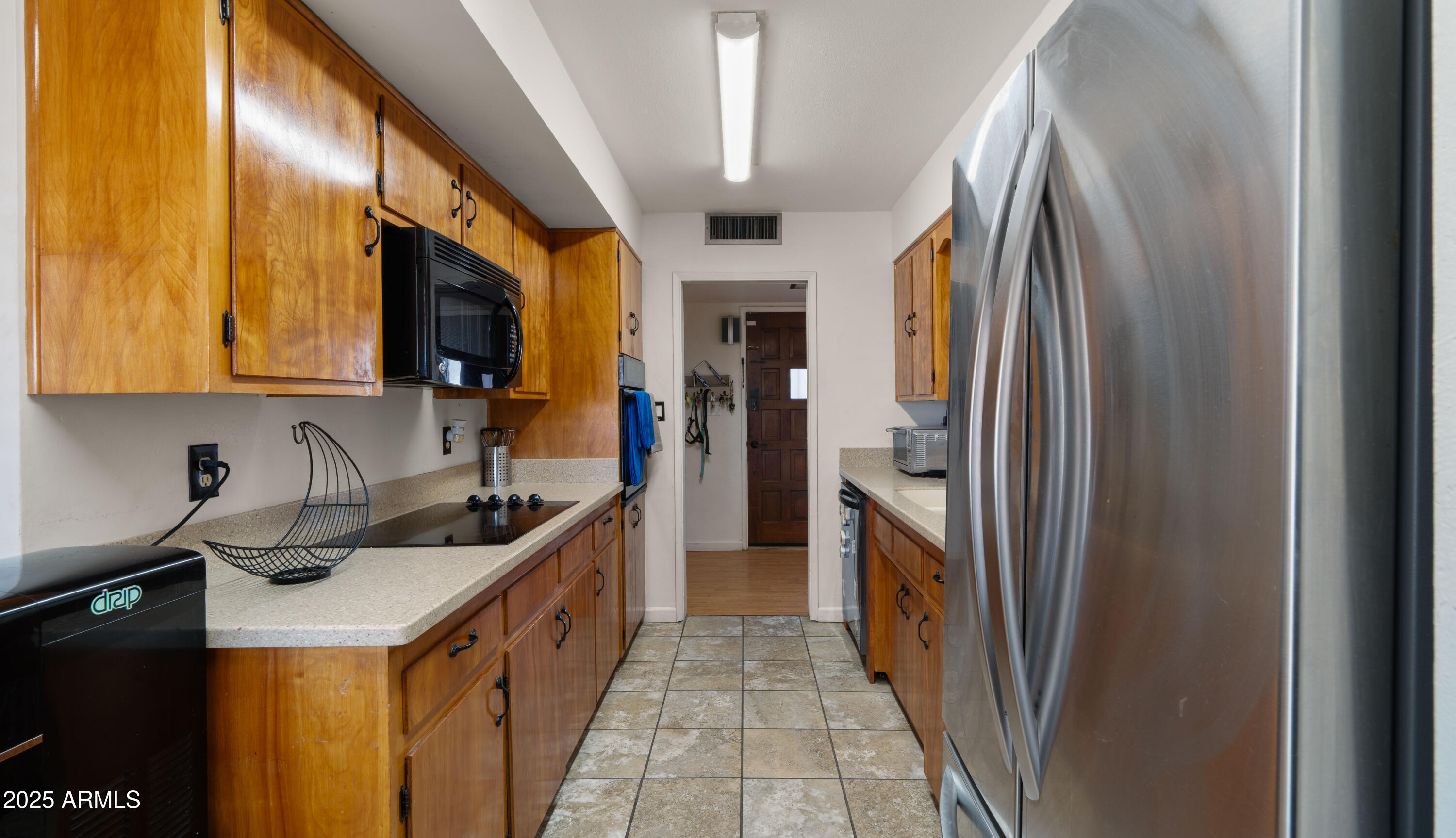 3501 East Coronado Road Phoenix, AZ 85008 - Photo 42 of 57 a kitchen with stainless steel appliances granite countertop a refrigerator a stove and a sink with wooden cabinets