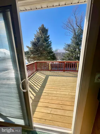 a view of a balcony with wooden floor and fence